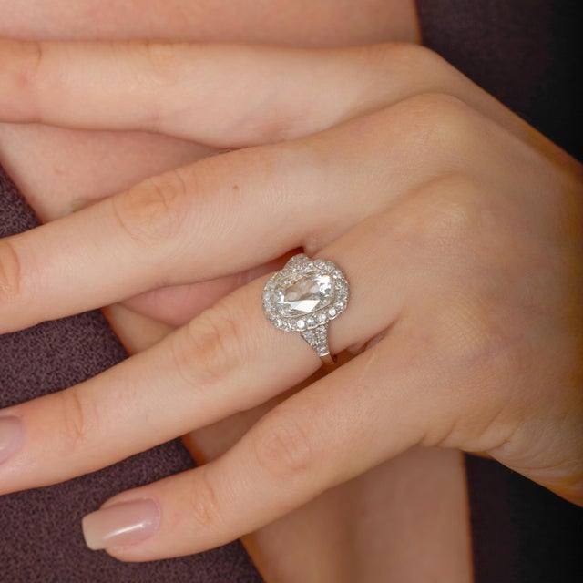 This beautifully crafted engagement ring brings the romance of antique diamond cutting into a refined modern setting,...
