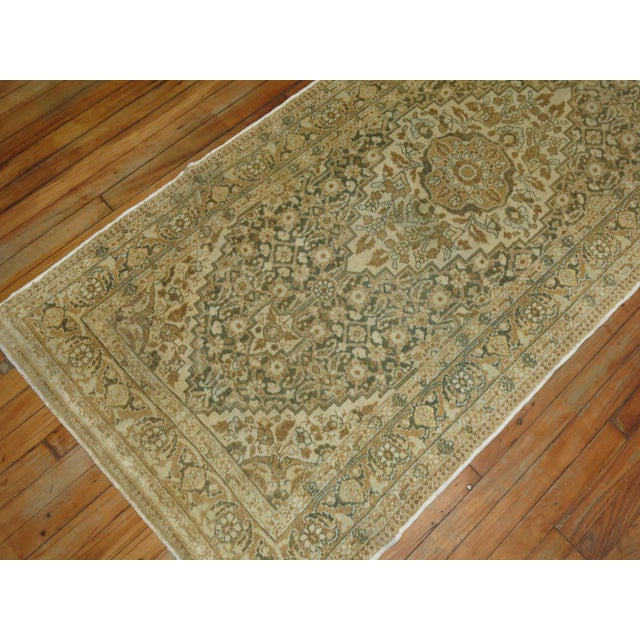 Antique Persian Tabriz runner. Predominantly Ivory, green and brown accents with 3 medallions on a Herati ground, circa...