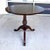 This Ethan Allen British Classics pedestal table features a round wood top supported by a carved pineapple-form column and...