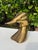 Vintage pair of sculptural duck bookends in an aged brass finish. Each bookend features a highly stylized, elongated duck...
