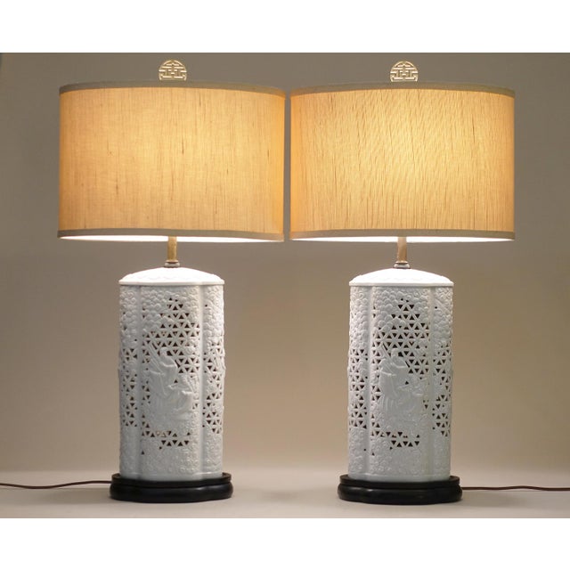 An impressive and visually stunning pair of large Hollywood Regency Modern sculptural Blanc De Chine reticulated relief...