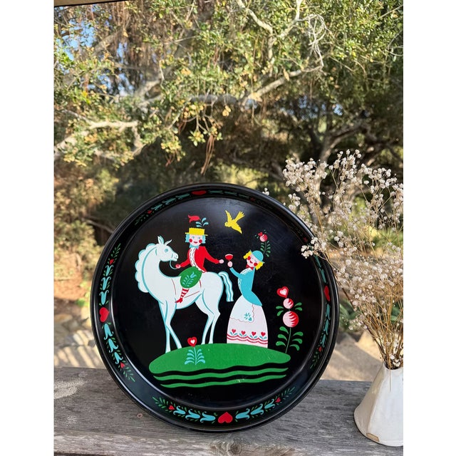 This is a vintage Scandinavian folk art metal serving tray. The tray features a courting couple, with the man on a horse,...