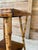 A wonderfully character-filled antique scorched bamboo side table featuring a square wood top, lower shelf and splayed...