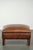 This ottoman is made of cowhide leather in a warm cognac color and is finished with decorative nails. A footstool, also...