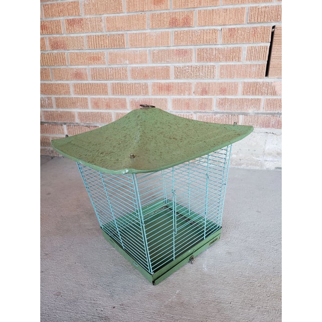 Wonderful mid-century birdcage by Reliance. The original color was teal but has aged into a beautiful faded green....