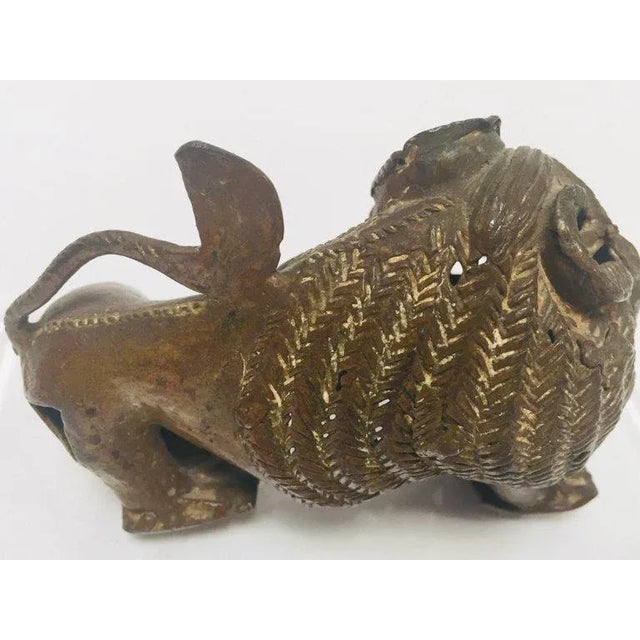 An antique unusual cast bronze of a Mythical lion beast. Bursting with character, the lion standing foursquare with his...