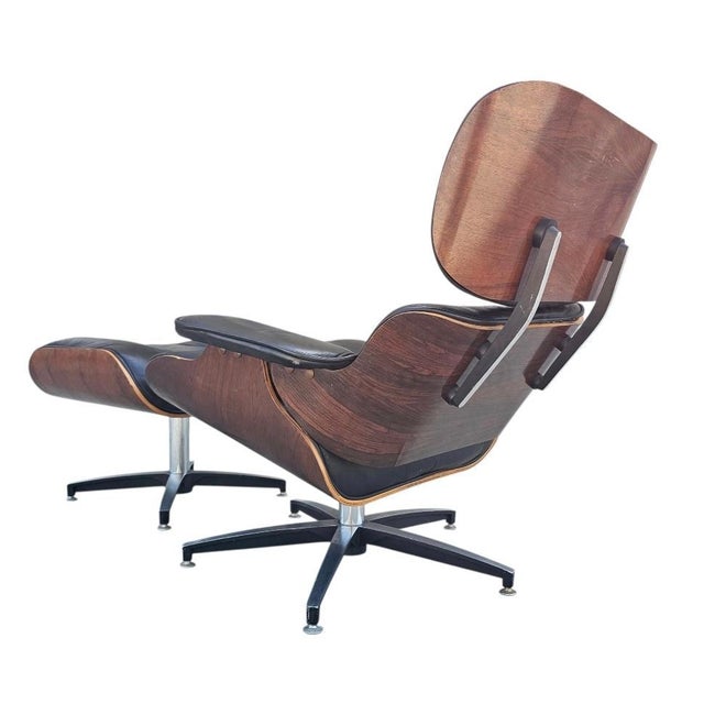 1970s vintage mid century modern lounge chair and ottoman in walnut with original black leather. The chair swivels, tilts,...
