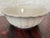 White glazed English ironstone bowl. Deep fluted panels run around the outside. The rim is softly scalloped. It works as a...