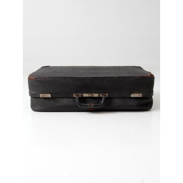 A vintage 1930s Belber suitcase in beautifully aged black leather with nickel-tone hardware and a deep green fitted...