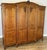 A beautiful Vintage French Louis wardrobe crafted from oak, featuring an elegant four door design with decorative carved...
