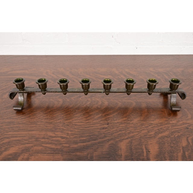 A gorgeous Arts & Crafts period hand hammered copper brass finished eight-light candelabra By Roycroft (signed with...