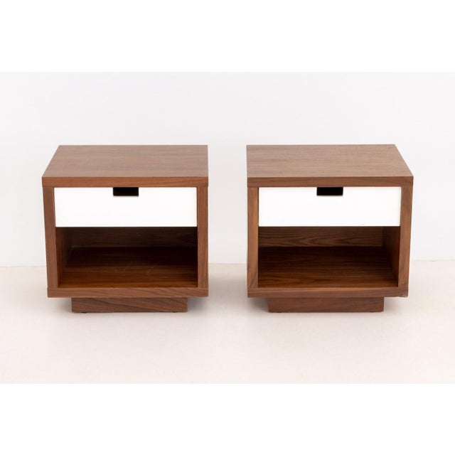 Pair of Gus Design Group Oak Bedside Tables, each with white laminate single pull drawer above an open shelf and label to...
