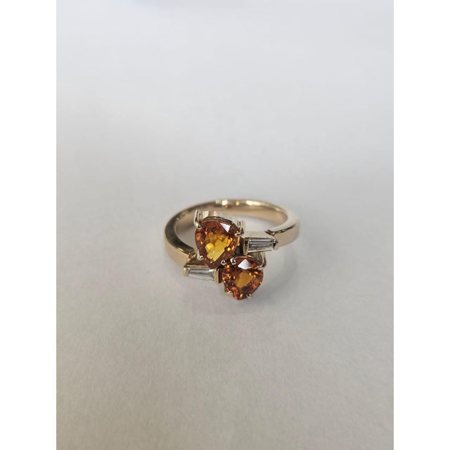 A very gorgeous and beautiful, modern style, Orange Sapphire Engagement Ring set in 18K Gold & natural Diamonds. The...