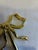 A charming vintage brass wall hook formed as a sculptural ribbon bow. Graceful loops, knotted center, and trailing ribbon...