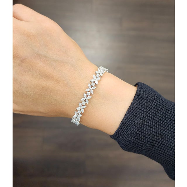 A modern tennis bracelet crafted in 18k white gold, featuring a stunning array of mixed-cut white diamonds totaling 7.67...