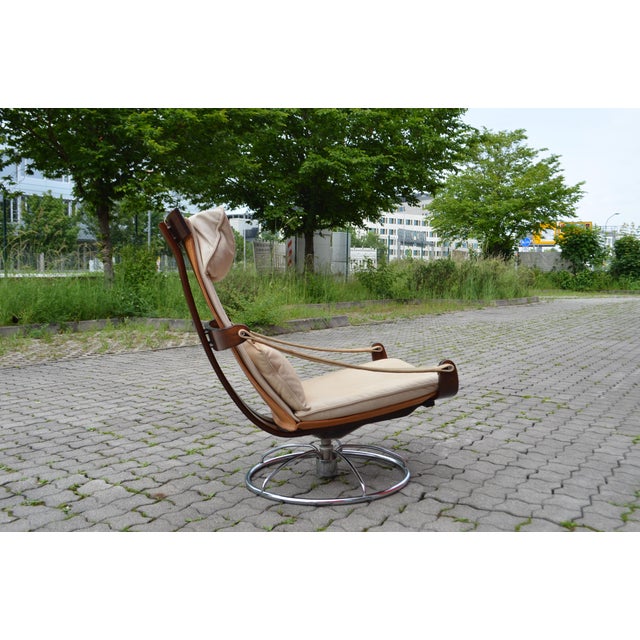 This Swivel Lounge Chair was designed by Ake Fribytter for Nelo, Sweden. It has of lightful design with beautiful wooden...
