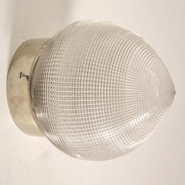 This ceiling light was manufactured by Holophane. It is made of nickeled metal and glass and has been rewired. Glass...