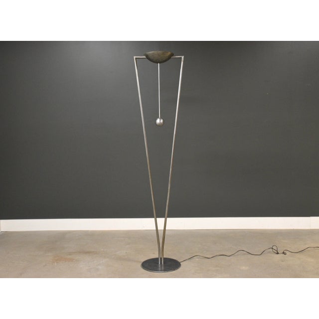 A post modern floor lamp by Ron Rezek made of brushed steel. Sphere twists as a dimmer and on off switch. Circa 1970’s....