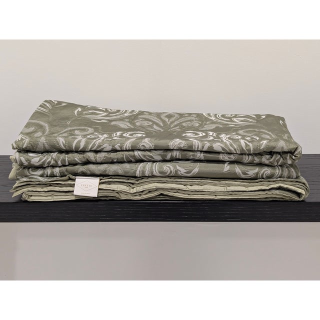 Fashioned in a soft and sumptuous mixture of linen and silk, this bedspread and shams showcase a scrolling jacquard...