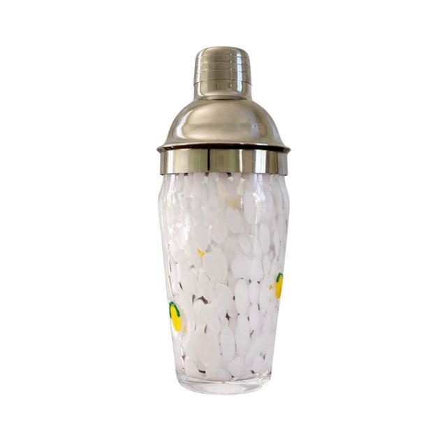 Time to shake up your at-home bar with this cocktail shaker, crafted from glass and stainless steel. Lemon and white...