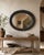 A striking late 19th-century oval wall mirror with a richly decorated ebonised frame and beautifully aged bevelled mirror...