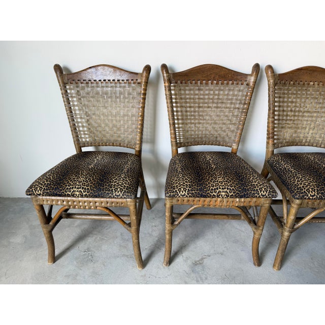 Elegant set of four vintage dining chairs crafted in the iconic McGuire style, featuring organic rattan frames with...