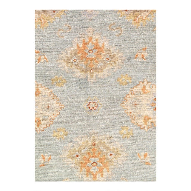 This Oushak Hand-Knotted Wool Teal Area Rug celebrated for its understated elegance, is greatly influenced by original...