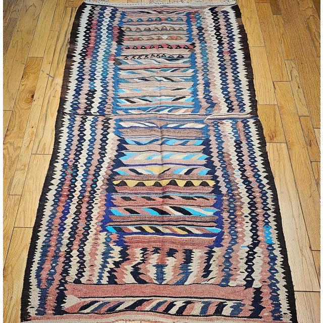 "This exceptional vintage flat-woven Kurdish kilim from Northwest Persia dates to the early 1900s and features one of the...