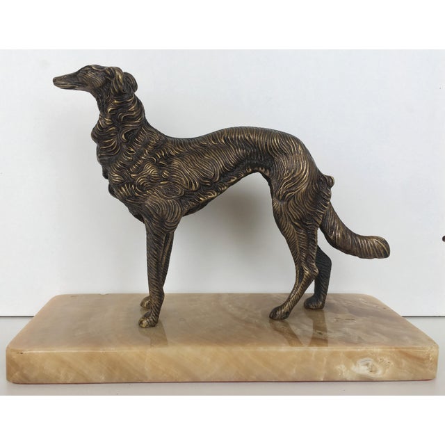 About A 19th century French silver patinated bronze greyhound on a cream marble base. A beautiful depiction of this sleek...