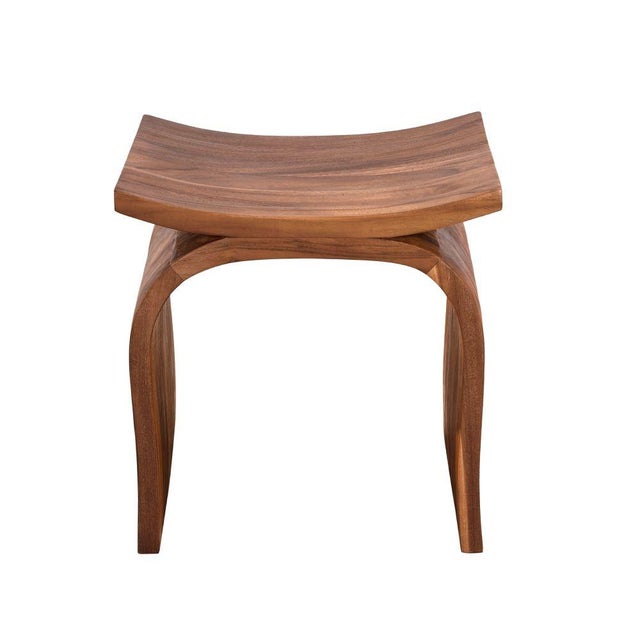 A sculptural, solid wood stool featuring curved, inverted-U-shaped legs and a saddle seat. The precise shaping highlights...