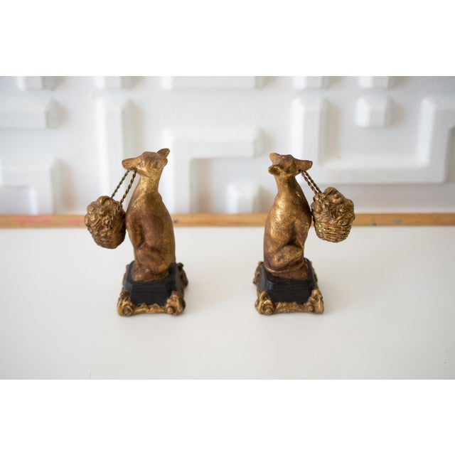 This listing is for a vintage pair of ceramic borzoi or hounds. Each holds a basket of fruit in it's mouth. The base is...