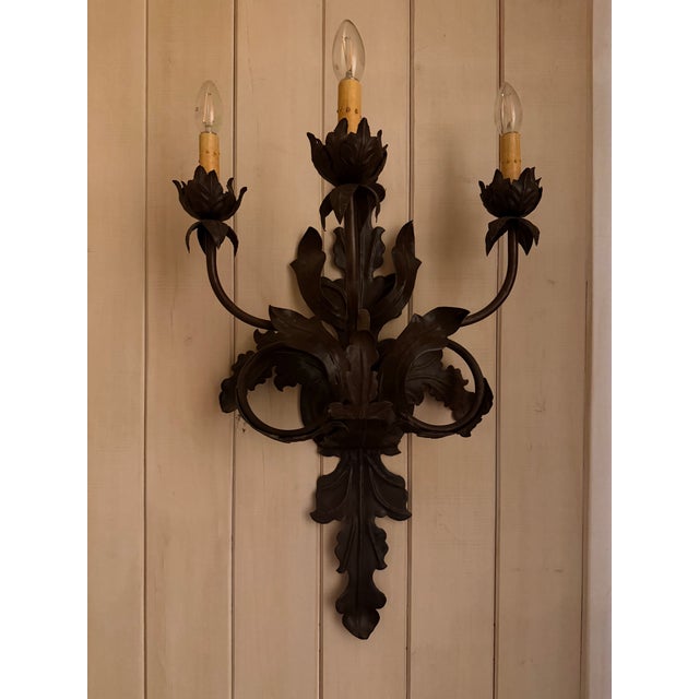Wrought Iron 3 light wall sconce with a leaf motif. Hardwired.