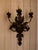Wrought Iron 3 light wall sconce with a leaf motif. Hardwired.
