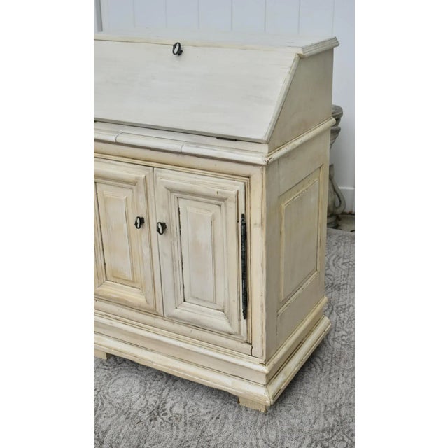 Vintage (1970's) Slant Front Desk has a Venetian Style. Distressed Antique White and Beige Finish. Features: Slant Front,...