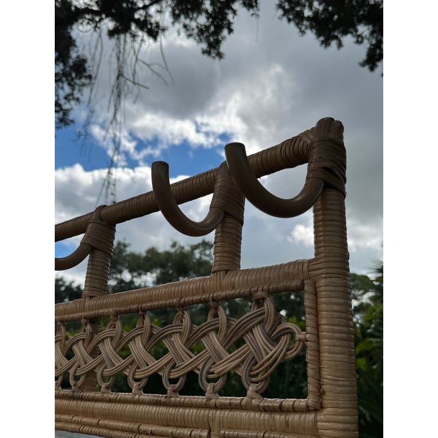 Beautiful vintage rattan and wicker hall tree featuring an intricate woven lattice frame, arched detailing, and a charming...