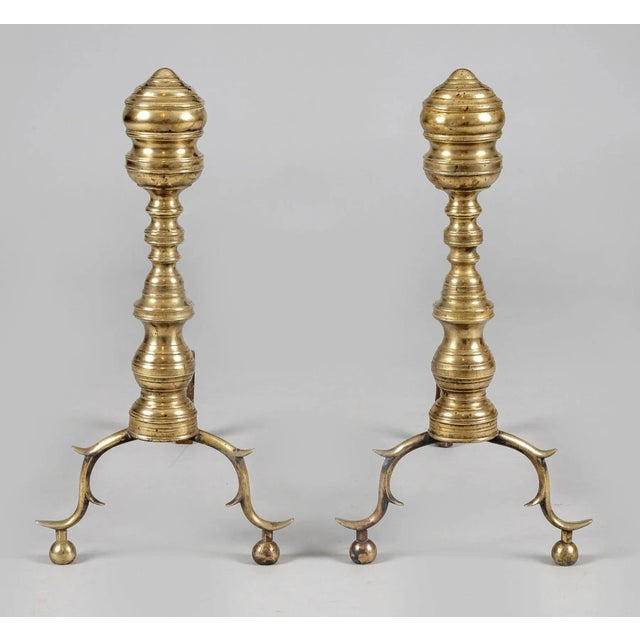 Pair of early 19th Century American brass andirons. The ribbed and turned finials and plinths are typical of the 1830’s....