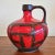A large glossy red and volcanic black 'Costa' decor vase designed by Otto Gerharz (decor) and Kurt Tschörner (form) for...