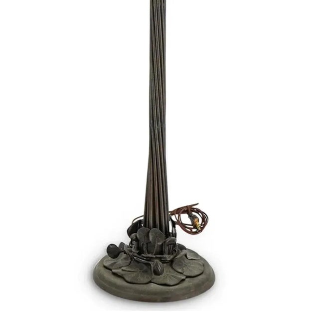 Style of Tiffany Studios floor lamp featuring an eighteen-light Lily form with patinated metal foundation, iridescent...