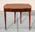 Elegant early 20th-century flame mahogany gate-leg table that doubles as a folding card table or antique writing desk. A...