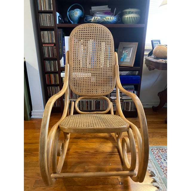 This chair is an original Mid-Century, Thonet Bentwood Rocker imported from France in the 1970s. The rocker is not a...