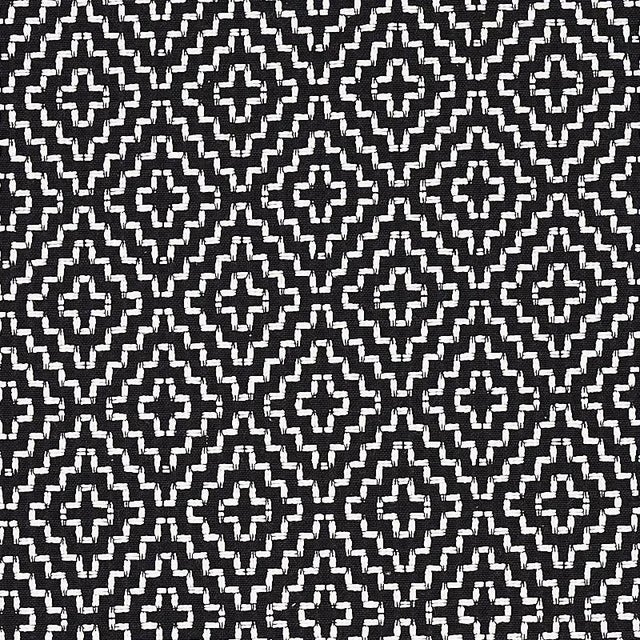With its nuanced tonal variations and cross-stitch pattern, this graphic fabric has the appeal of a handcrafted textile....