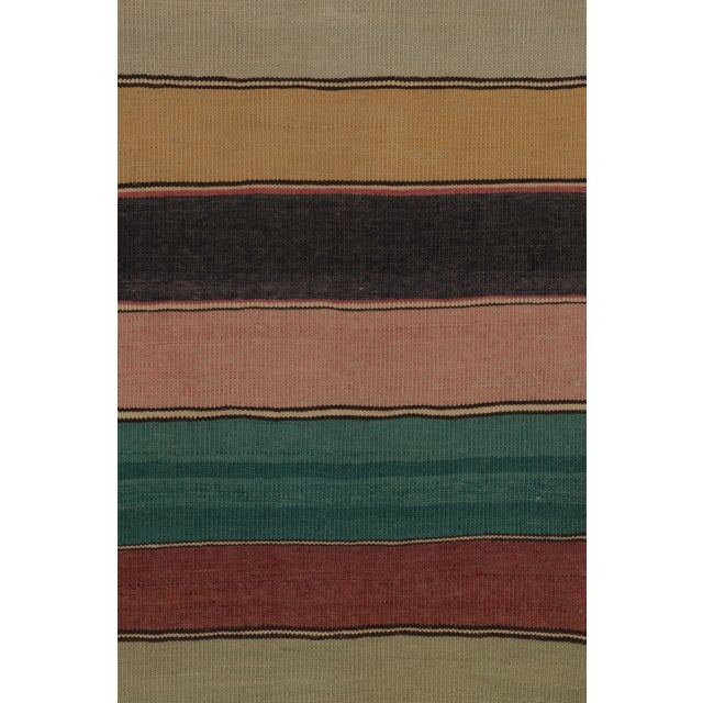 Handwoven in wool, this 6x9 contemporary Indian Rez Kilim features layered multicolor stripes in earthy, muted hues. Its...