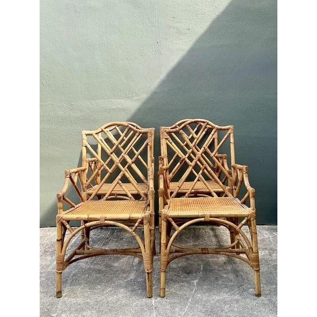 Elevate your dining space with this exceptional set of four vintage Chinese Chippendale style rattan armchairs. Expertly...