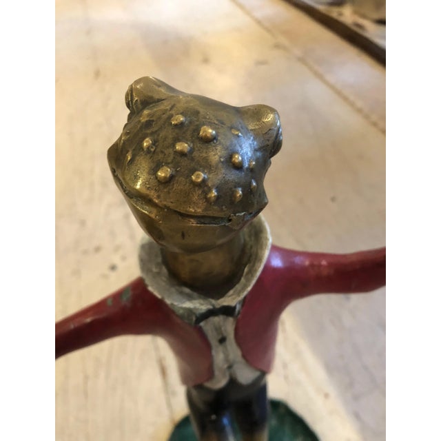 Charming pair of painted bronze candlesticks, one is a dapper Mr. dancing frog in red jacket, and his partner is a tutu'd...