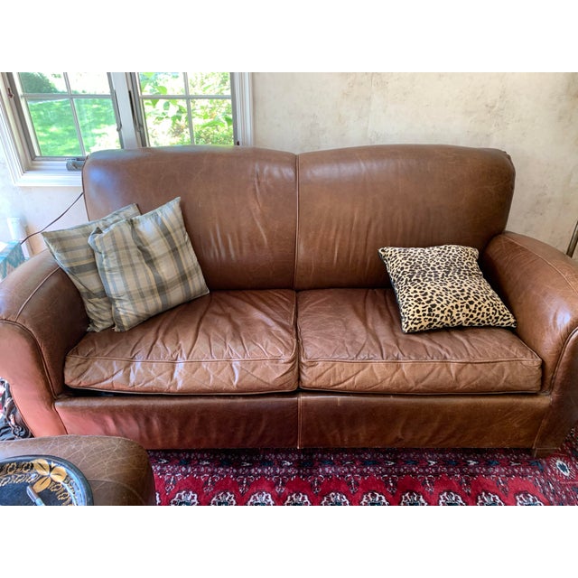 Bought from Pottery Barn in early 1990s . This is the classic Manhattan 1930s style leather club sofa with a pullout...
