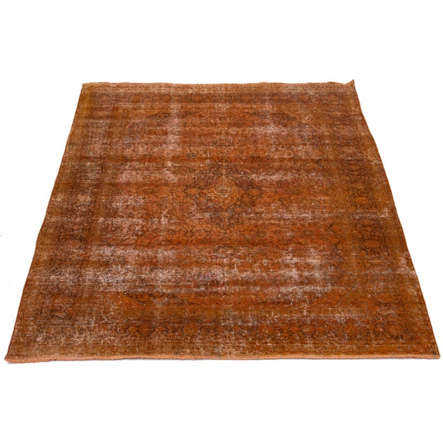 This orange, antique, hand-knotted Persian wool rug has a medallion floral design with brown and beige accents. This rug...