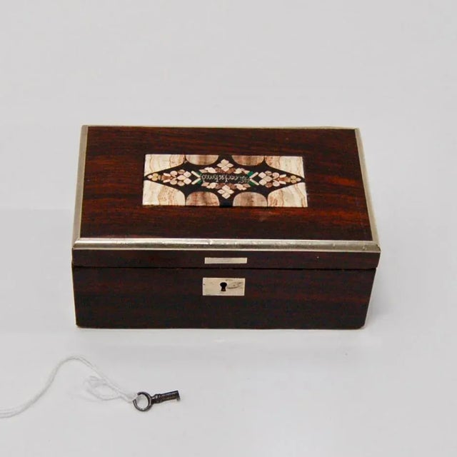 This is a late 19th century Austrian rosewood Karlsbad box featuring a beautiful Pietra Dura lid marked "Karlsbad" in the...