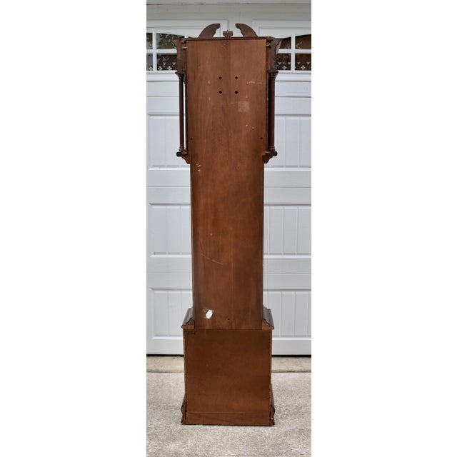 Vintage (1980s) Grandmother Clock has a Traditional Style. Mahogany, Embossed Dial, and Brass Finial. Mechanical - Chain,...