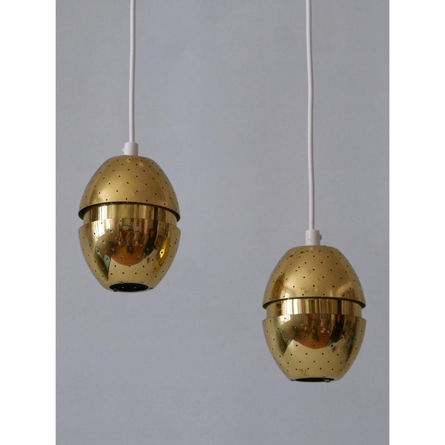 Set of two rare, lovely and highly decorative mid-century modern egg-shaped perforated brass 'florina t790' pendant lamps...