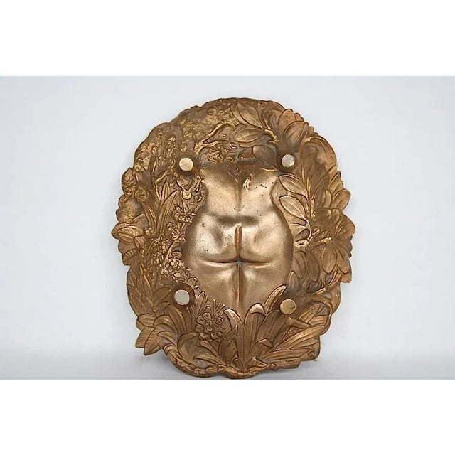 This Art Nouveau bronze dresser pin tray is a fine example of a "naughty," a decorative dish with an image of a woman that...